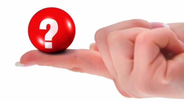 Red bowling ball with question mark on finger representing bowling ball materials question