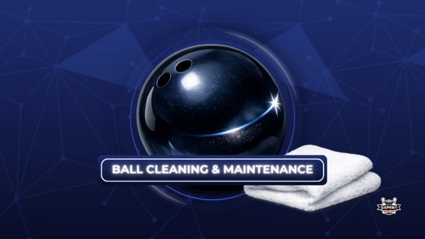 An educational graphic by "Expert Bowler" titled "BALL CLEANING & MAINTENANCE" against a dark blue background with geometric network patterns. The image features a glossy, black "T-Zone Night Sky" bowling ball with white sparkles and a light flare on the side. To the right of the ball, there is a neatly folded, fluffy white microfiber towel. The "Expert Bowler" logo is visible in the bottom right corner.